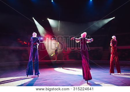 The Performance Of Stilt-walkers In The Circus
