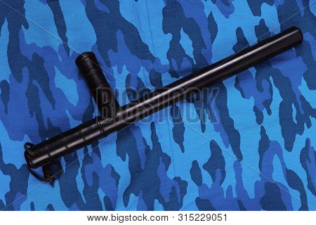 Black Rubber Baton On Blue Urban Russian Riot Police Camouflage Flat Lay