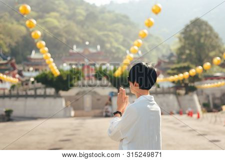 traveling woman praying at BaoHu Dimu Temple at Puli, Nantou, Taiwan, Asia