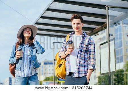 Strangers Girl And Guy Waiting For Bus On The Street Outdoor. How Acquaintances With Man Concept.
