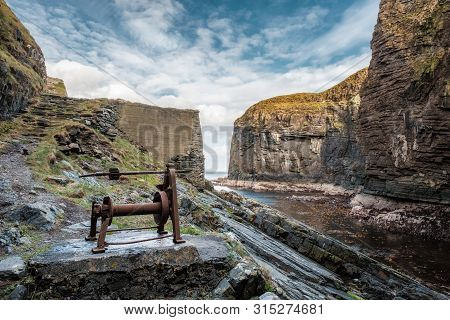 An Old Hand Powered Boat Winch On The Rocks At The Entrance To Whaligoe Harbour Near Wick In Caithne
