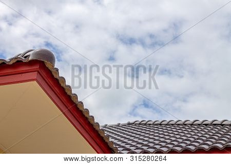 The Gable Roof With The Sky With Clouds Background.
