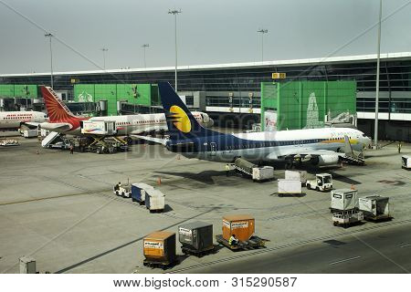 Aircraft And Indian People Prepare To Take Off And Loading Baggage To Plane In Indira Gandhi Interna