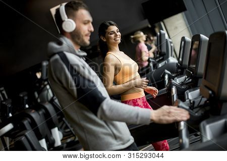 Young People Using Threadmill In Modern Gym