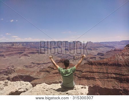 Sitting On The Edge Of A Deep Descent In The Beautiful Grand Canyon National Park
