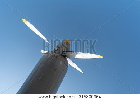 Airplane Propeller Of Military Aircraft, Copy Space. Blue Sky Background.