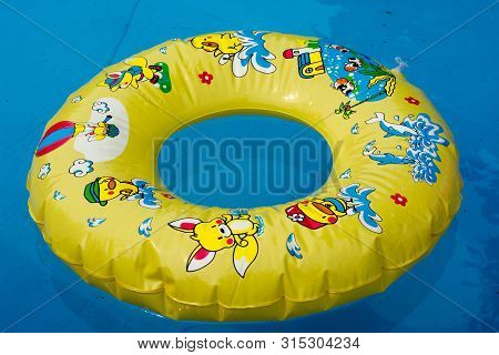 Floating Ring On Blue Water Swimpool With Waves Reflecting In The Summer Sun