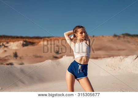 Young Woman Stretching And Warming Up At The Nature. Attractive Girl Stretching Before Fitness. Beau