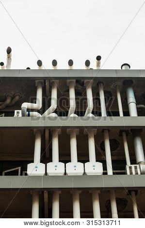 Close Up Of The Factory Building With The Blue Sky.the Air Duct System Where Installed At The Factor