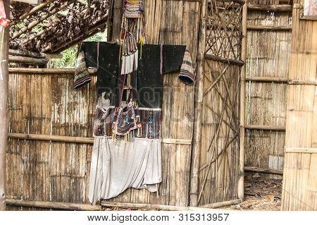 Colorful Tribal Costumes On The Bamboo Wall