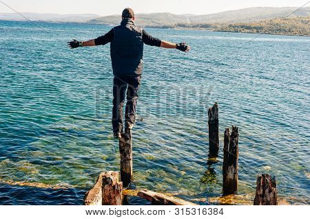 Man On Rock On Olkhon Island In Lake Baikal, Russia