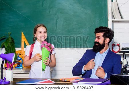 Teachers Day. Daugghter And Father With Flowers. Knowledge Day Is 1 September. Flower Present For Be