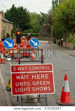 A Set Of 3-way Lights Control The Flow Of Traffic At A Village Junction