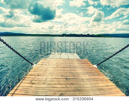 Shipping On Ferry Boat Ship With Open Ramp And Empty Car Deck. Wooden Board For Cars And Passenger