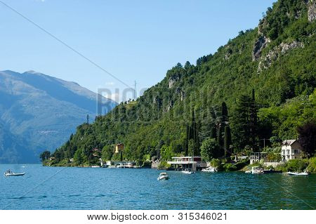 View Of Mountain Lake On A Sunny Summer Day. District Of Como Lake, Colico, Italy, Europe