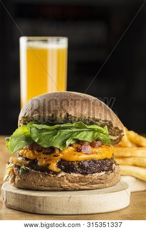 A Delicious Hamburguer With Fries And Juice
