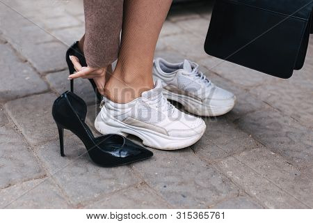 Barefoot Business Woman Shanging Shoes From High Heel To Comfortable Sneaker