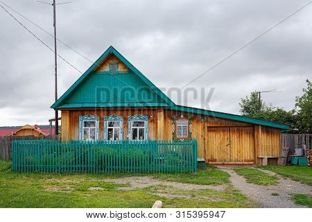 Visim, Russia - June 24, 2015. Village Street In Summer. Beautiful Wooden Country House. Village Of 