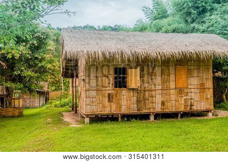 Chiang Mai, Thailand; July 2, 2019: Side View Of Traditional Thatched Roof House With Open Window Lo