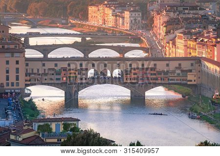 Aerial View Of Arno River With Ponte Vechio At Sunset. Florence, Italy
