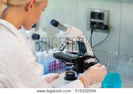 Female Scientist Working In Modern Lab. Doctor Making Microbiology Research. Laboratory Tools: Micro