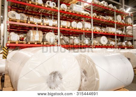 Racks of rolled and packed polyethylene film in storage area