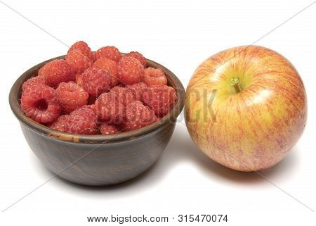 Apple And Raspberries In A Cup On A White Background