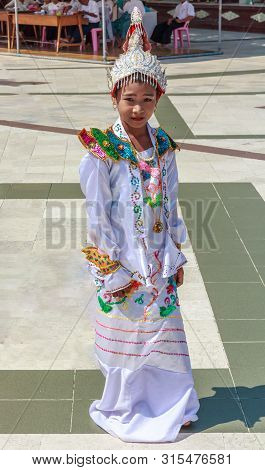 Yangon, Myanmar-may 6th 2014: Girldressed For Religious Ceremony In Shwedagon Pagod. The Pagoda Is T