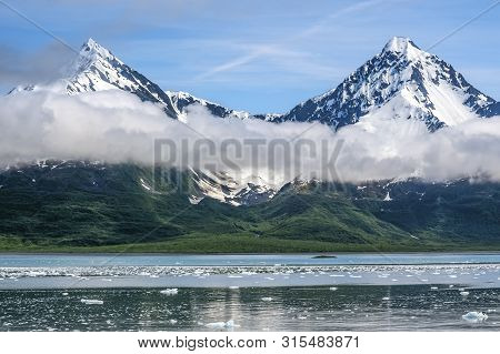 Broken Ice And Snow Capped Mountains  Near The Aialik Glacier In Kenai Fjords National Park In Alask