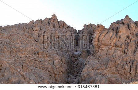 A Crevice In A Mountain Range In The Desert Of Egypt In The Afternoon.