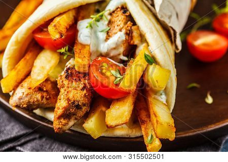 Gyros Souvlaki Wraps In Pita Bread With Chicken, Potatoes And Tzatziki Sauce, Blue Background.