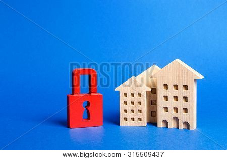 Three Houses And A Red Padlock. Unavailable And Expensive Real Estate. House Insurance. Security And