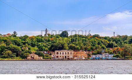 Havana, Cuba, July 2019, View Of The Coast Of Regla With The Christ Of Havana On A Hill In The Subur