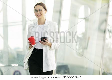 Business Woman With Phone On Street. Portrait Of Smiling Beautiful Young Female In Stylish Clothes C
