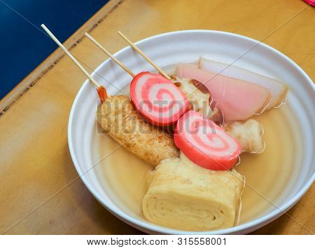 Oden Stick Fish And Tamago Egg With Hot Soup On Wooden Table, Japanese Food Gourmet.