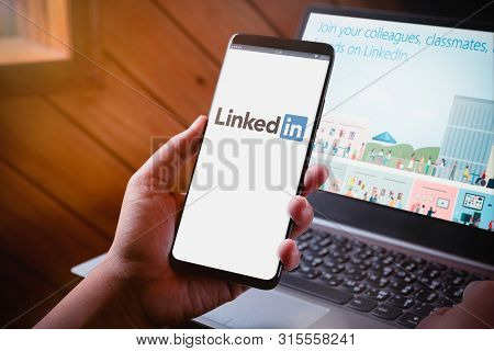 Bangkok, Thailand - August 5, 2019: Hands Holding Smartphone With Linkedin Logo On Screen And Linked