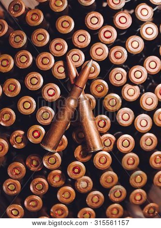Bullets On A Wooden Background. Military Concept.