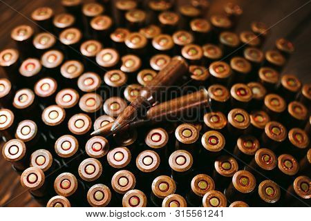 Bullets On A Wooden Background. Military Concept.