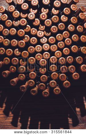 Bullets On A Wooden Background. Military Concept.