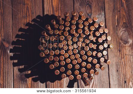 Bullets On A Wooden Background. Military Concept.