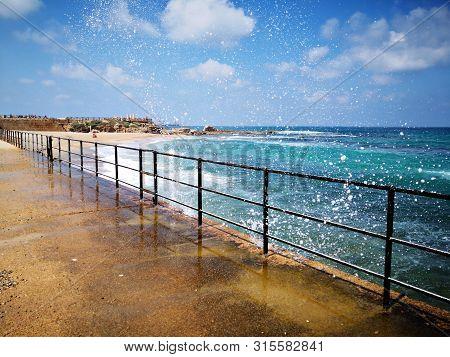 Seascape With Blue Waters, Water Splash And And Sky. Cesarea, Israel
