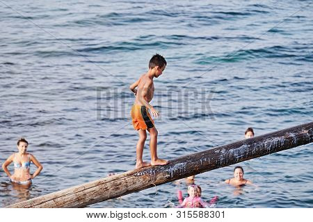 Xghajra, Malta - August 3, 2019: Traditional Maltese Game Of Gostra, Where Is Brave Local Men Would 