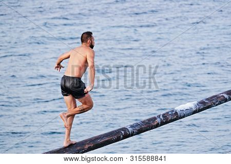 Xghajra, Malta - August 3, 2019: Traditional Maltese Game Of Gostra, Where Is Brave Local Men Would 