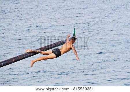 Xghajra, Malta - August 3, 2019: Traditional Maltese Game Of Gostra, Where Is Brave Local Men Would 