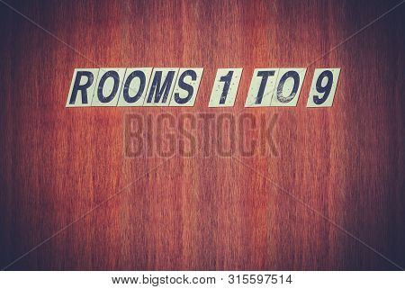 Grungy Retro Sign For Rooms On An Old Wooden Door At A Hotel, Motel, Boarding House, Hostel Or Bedsi