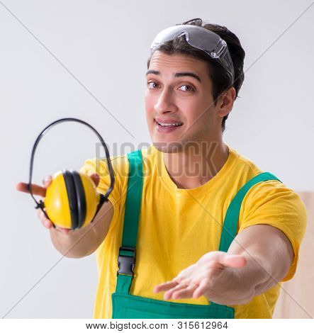 Worker showing the importnace of wearing noise cancelling headph