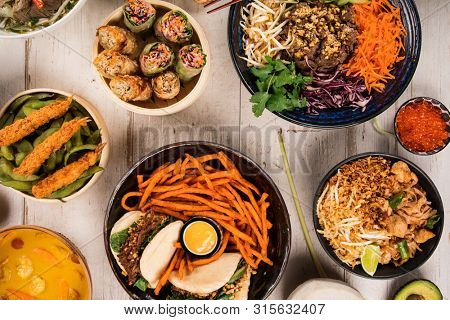 Asian food background with various ingredients on rustic wooden background , top view. Vietnam or Thai cuisine.