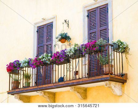 Verona, Italy - July, 8, 2019: balkony of a dwelling house in a center of Verona, Italy