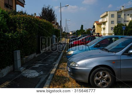 Rovigo, Italy - July, 7, 2019: cars parked on the street in Rovigo, Italy