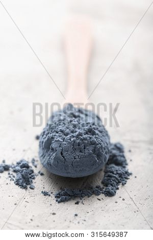 Blue Tea Matcha In A Spoon On Concrete Surface. Close Up Shot